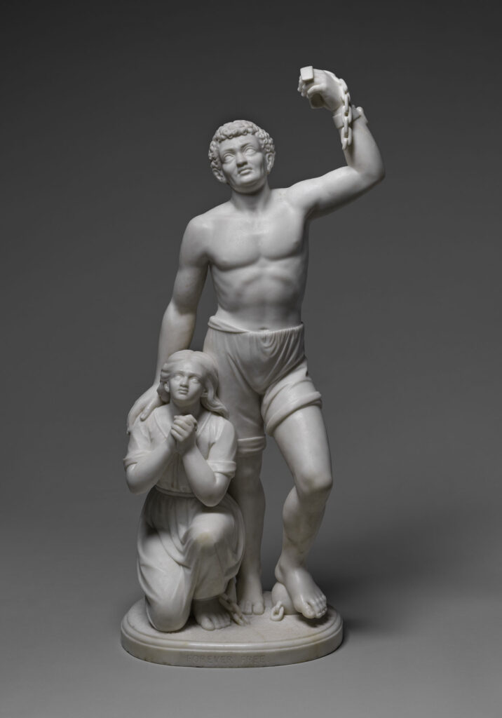 Forever Free, a marble sculpture of a standing man raising a broken chain beside a kneeling woman