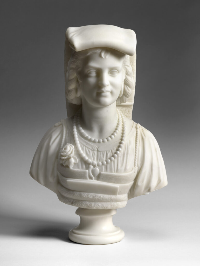 Marble bust of a young woman wearing a folded cap and bead necklaces