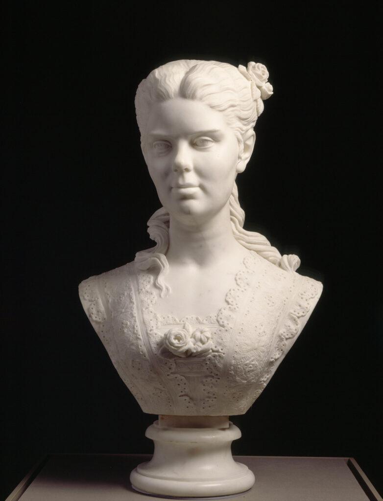 Marble bust of a woman with swept-back hair, a rose, and a lace-trimmed bodice